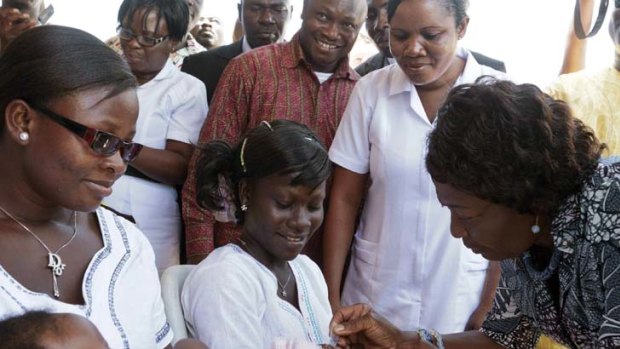 Milestone ... Ghana's first lady, Ernestina Naadu Mills (right), vaccinates a six-week-old baby against rotavirus. Ghana is the first African country to simultaneously introduce rotavirus vaccine and pneumococcal vaccine.