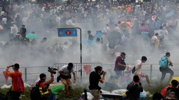 Protesters flee tear-gas near Hong Kong's government headquarters.