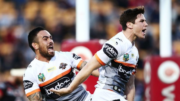 Much improved: Mitchell Moses celebrates with teammate Dene Halatau after scoring a try during the round 25 NRL match between the New Zealand Warriors and the Wests Tigers at Mount Smart Stadium.