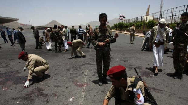 Aftermath ... military police collect evidence at the site of the suicide bomb attack.