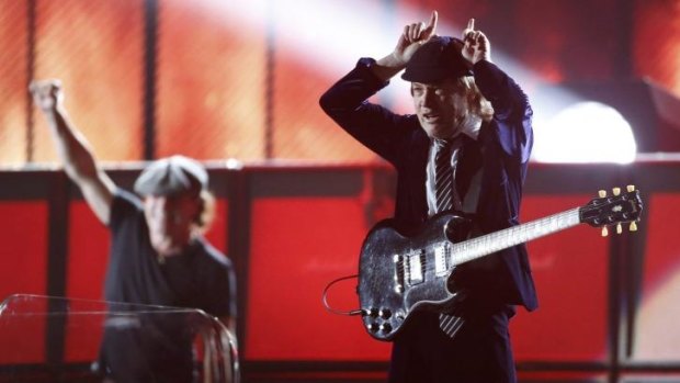 Angus Young of AC/DC puts on 'horns' at the 57th annual Grammy Awards in Los Angeles.