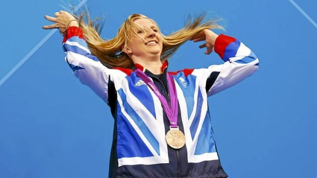 Britain's Rebecca Adlington tosses her hair back as she poses with her 400m freestyle medal. Its colour was bronze though and not gold.