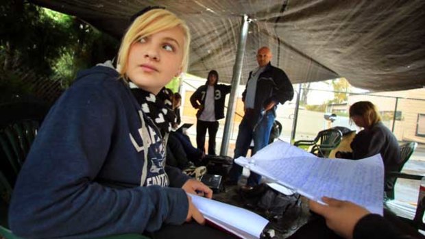 Jon Carnegie teaches students under a tarp in the carpark.