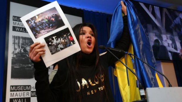 Ruslana the activist singing the Ukrainian national anthem in Berlin in February. 