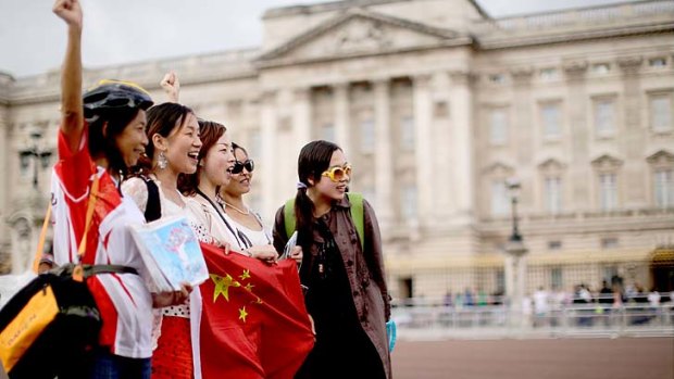 Chinese tourists outside Buckingham Palace in London. Chinese tourist numbers are booming, with Hong Kong, Macau and South Korea the favourite destinations.