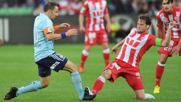 Sydney veteran Alessandro Del Piero is tackled by Robbie Wielaert of the Heart during the round six A-League match at AAMI Park.