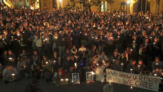 Crying out for change: Hundreds take part in the candlelight vigil at Sydney's Town Hall.