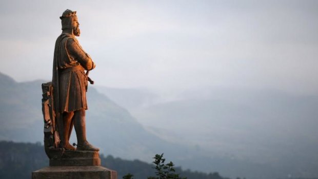 A statue of King of the Scots Robert the Bruce looks out over a misty Stirling, Scotland.