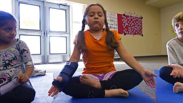 Classroom peace: First-grader Miriam Ruiz practises her yoga at a school in Encinitas, California.