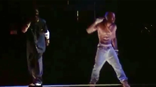Brought back to life ... Snoop Dogg, left, performs on stage with the eerie, but incredibly convincing Tupac hologram.