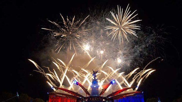 Jubilee fun ... Buckingham Palace is illuminated by a fireworks display.