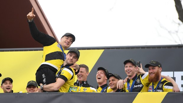 Trent Cotchin pretends to throw Dustin Martin off the stage at Richmond’s Family day on Sunday at the Punt Road Oval. 