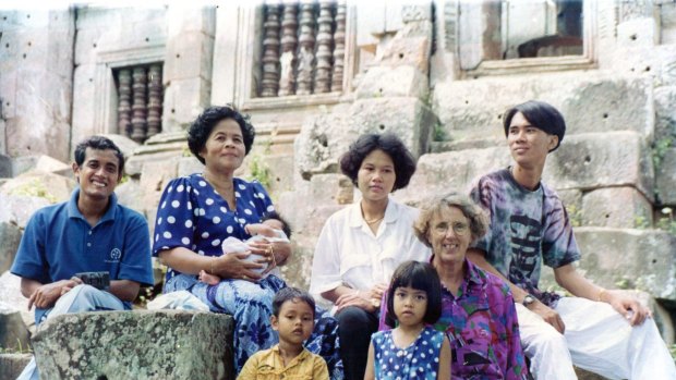 Joan Healy (front right) spends time with a Cambodian family during a visit to the ruins of a Khmer Monastery in Battambang Province in 1993.