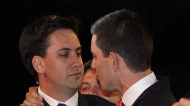Ed Miliband, left, newly-elected leader of Britain's Labour Party, embraces his brother and rival David Miliband.