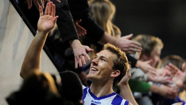 Up close and personal: North Melbourne's Drew Petrie celebrates with fans.