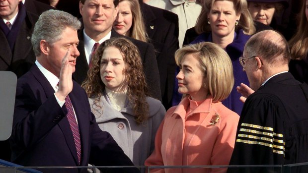 Supreme Court Chief Justice William Rehnquist, in his self-designed black robe with four gold stripes, swears in US President Bill Clinton in January 1997. 