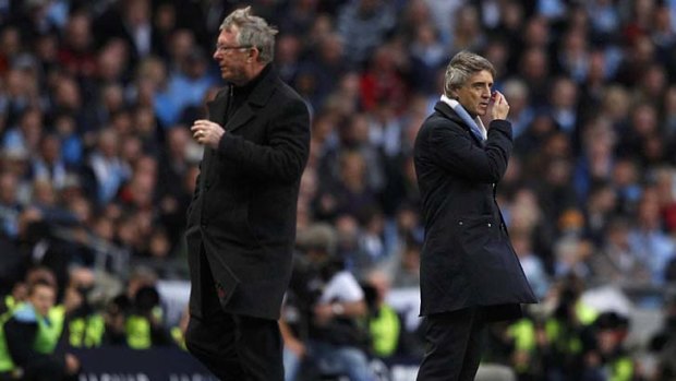 Arch rivals: Alex Ferguson and Roberto Mancini during the Manchester United and Manchester City clash.