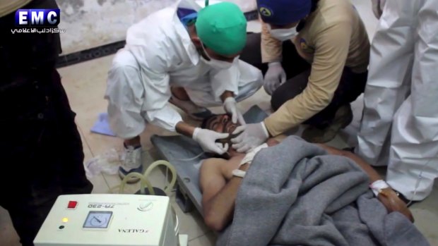 A victim of a suspected chemical attack receives treatment at a makeshift hospital.