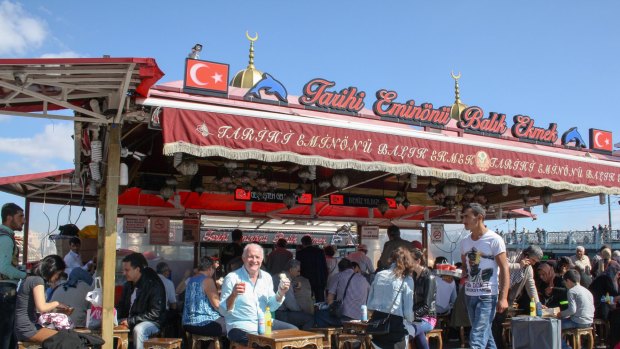 Rick Stein enjoys a Balik Ekmek (Istanbul's famous fish sandwich) by the shores of the Bosphorus, Istanbul, in Rick Stein: From Venice to Istanbul.