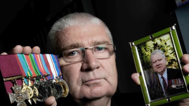 Son of an Australian who wouldn't give up &#8230; Rob Kenna with a photo of his father, Ted, and the medals earned in battle.