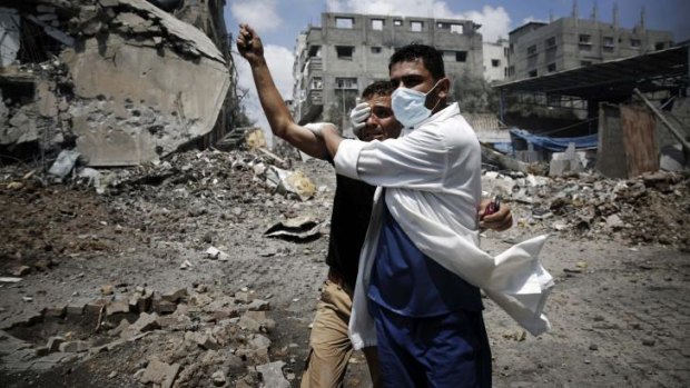 A medic helps a Palestinian in the Shujaiya neighbourhood, heavily shelled in the latest Israeli offensive in the Gaza Strip.