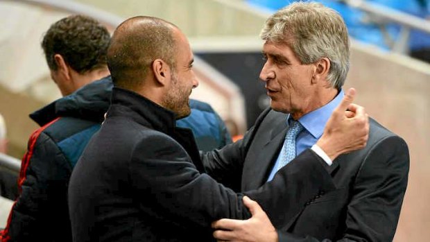 Manchester City manager Manuel Pellegrini (R) is embraced by Guardiola.
