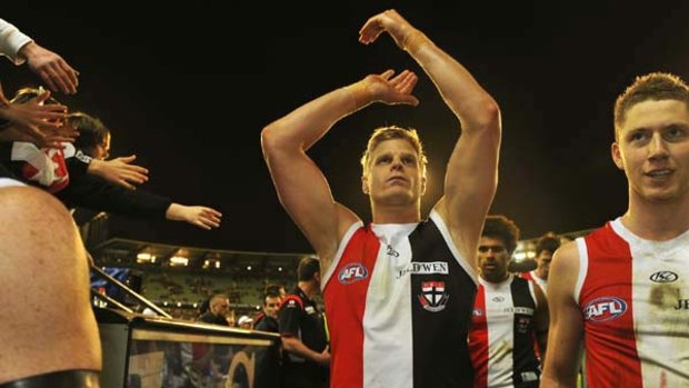 St Kilda skipper Nick Riewoldt acknowledges supporters as he leaves the arena last  night with his teammates, including defender Zac Dawson.
