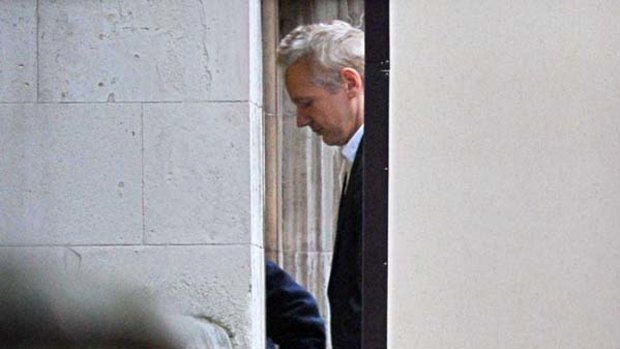 Julian Assange is led into London's High Court yesterday.