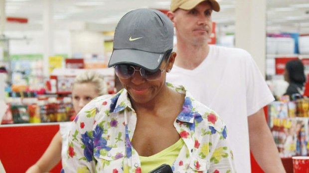 First lady ... Michelle Obama, wearing a hat and sunglasses, stands in line at a Target Department store in Virginia.