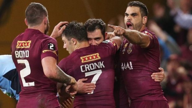 Maroons celebrate after Cameron Smith's opening try in game three.