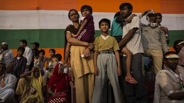 Election: A family listens as Rahul Gandhi, of India's ruling Congress party, speaks at a rally. Voters appear ready to reject Congress.