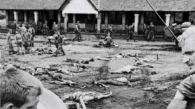 Dead Vietnamese soldiers are documented before burial.