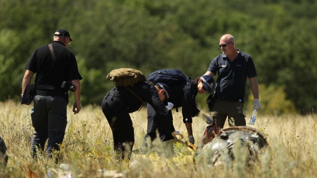 Australian Federal Police search at the MH17 crash site for human remains.