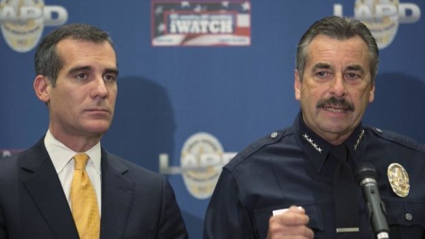 Los Angeles Police Chief Charlie Beck,right, addresses threats made by Sony Studios hackers.