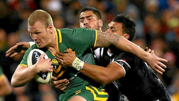 On the charge: Luke Lewis in action for Australia.