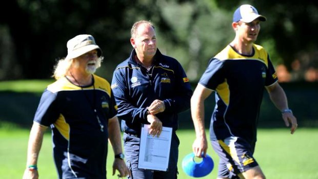 Brumbies coach Jake White (centre) with his assistant coaches Laurie Fisher and Stephen Larkham.