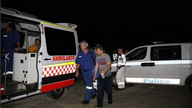 Rescue: One of the survivors is helped to an ambulance last night after the accident at Frazer Park.