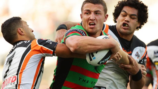 Hard to stop ... Sam Burgess of the Rabbitohs takes on the Tigers' defence.
