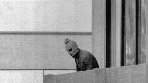 Dark day ... an unidentified member of a terrorist group appears on the balcony of the building where members of the Israeli Olympic team were being held hostage during Munich Olympics in September 1972.