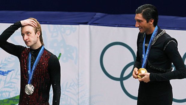 Gold medallist Evan Lysacek  looks at silver medallist Yevgeny Plushenko.