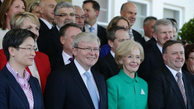 Prime Minister Kevin Rudd poses for photos with his new-look ministry after the swearing-in ceremony at Government House with Governor-General Quentin Bryce, in Canberra on Monday July 1, 2013.