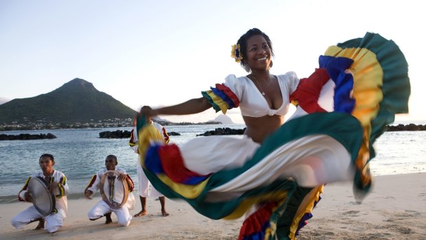 Swirling colours: A woman performs the sega, the national dance of Mauritius.
