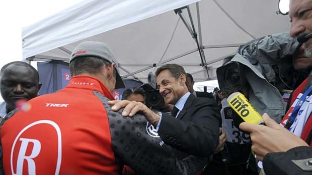 France's President Nicolas Sarkozy (C) shakes hands with Lance Armstrong.