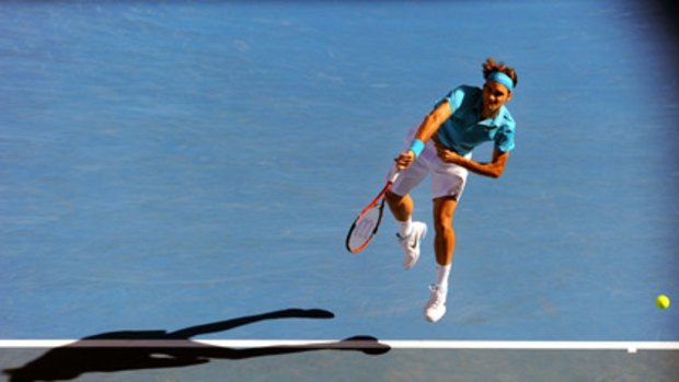 Roger Federer serves during his quarter-final against Nikolay Davydenko.