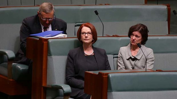 An emotional Julia Gillard listens to Rob Oakeshott's valedictory speech where he paid tribute to her, on what was her last day in Parliament.