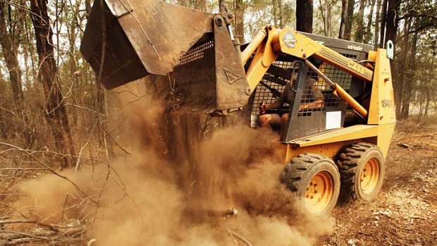 Preparing for the fires: Damien Stevens clearing his land with a bulldozer.
