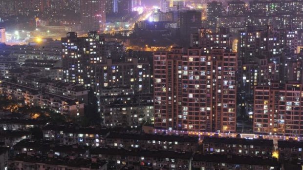 Chinese home prices fell for a fifth straight month in September: a night view of residential buildings in Hefei, Anhui province.