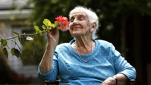 "As tough as old boots": Dame Elisabeth Murdoch enjoys the fragrant delight of the hardy rose named in her honour.