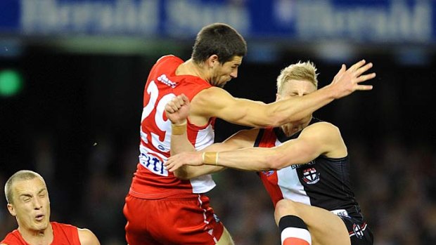 Pas de deux: It's almost Swan Lake  in footy boots as Martin Mattner and Nick Riewoldt clash last night.