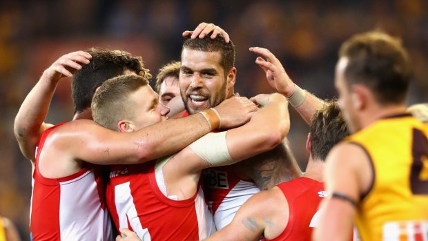 Lance Franklin is congratulated by Sydney Swans teammates after kicking a goal during the side's round nine victory over Hawthorn at the MCG on May 20, 2016. 